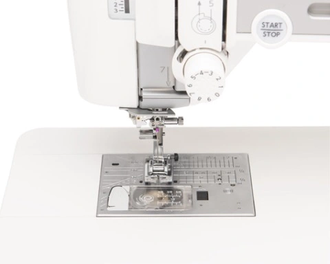 Close-up of the Janome MC6700P advanced AcuFeed Flex layered fabric feeding system handling thick quilt layers near Raleigh, NC.