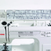Close-up of the Janome HD-3000 flip-top storage lid showing the built-in stitch selection guide and feet settings near Raleigh, NC.