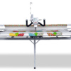 Janome Quilt Maker Pro 18 longarm quilting machine set up on its 12-foot steel frame inside the showroom of The Broken Needle in Bunn, NC.