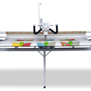 Janome Quilt Maker Pro 18 longarm quilting machine set up on its 12-foot steel frame inside the showroom of The Broken Needle in Bunn, NC.