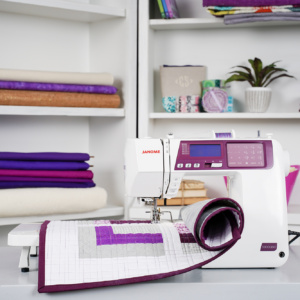 Janome 5300 QDCG computerized sewing machine shown on a studio quilting table at The Broken Needle showroom in Bunn, NC.