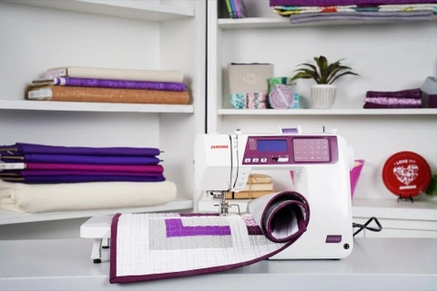 Close-up of the purple Janome 5300QDC backlit LCD screen display showing 300 built-in sewing stitches near Raleigh, NC.