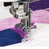 • • Detailed view of a custom quilt pattern being sewn using the specialized clear view foot on a Janome Continental M6, serving creators in Wake Forest and Louisburg.