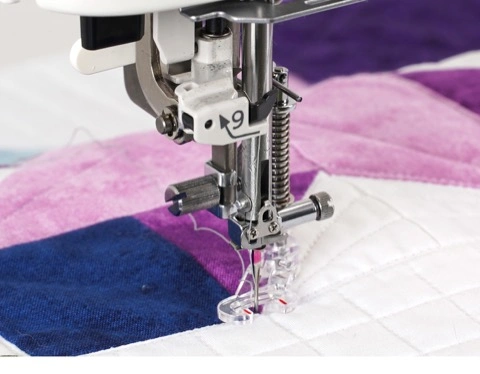 • • Detailed view of a custom quilt pattern being sewn using the specialized clear view foot on a Janome Continental M6, serving creators in Wake Forest and Louisburg.