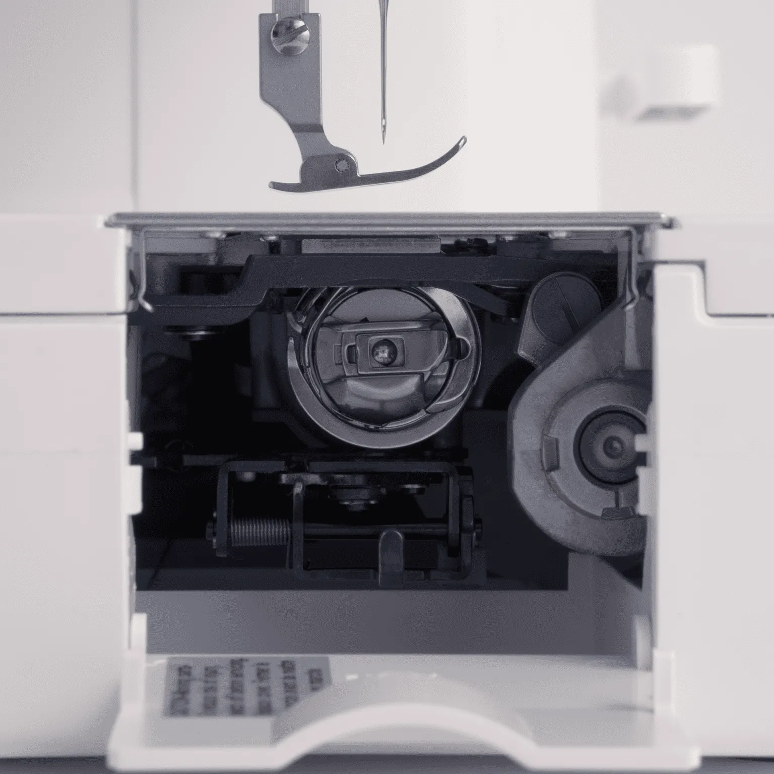 Close-up of the Janome industrial vertical full rotary hook bobbin case available near Raleigh, NC.