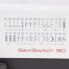 Janome SewSwitch 30 internal components showcasing the adjustable cutting width and overlock feed length gears near Wake Forest, NC.